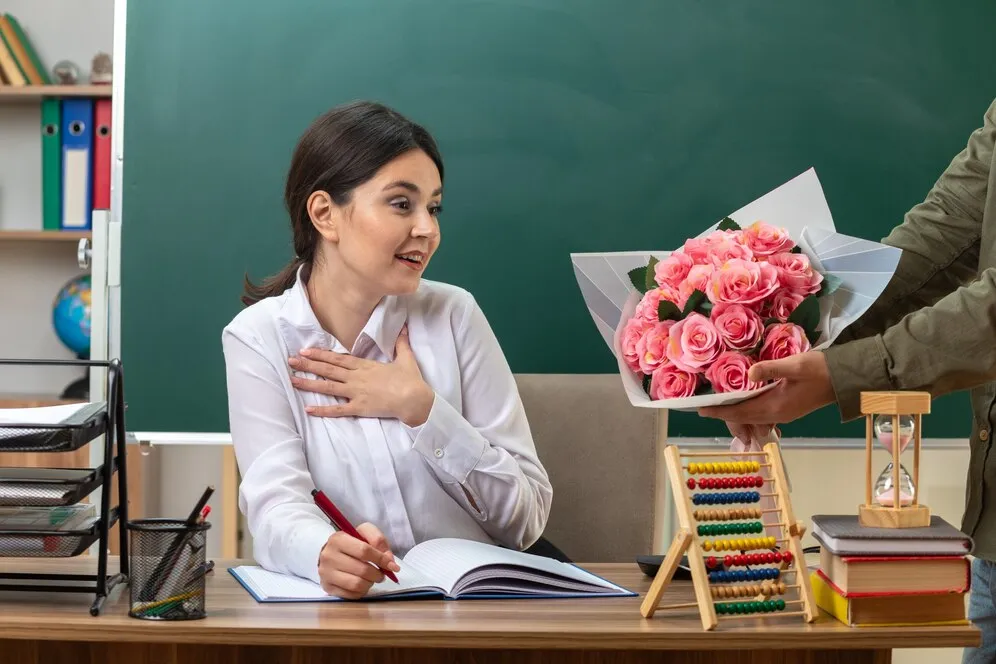 surprised-putting-hand-heart-young-female-teacher-writes-notebook-gives-bouquet-by-someone-sitting-table-with-school-tools-classroom_141793-113967.jpg surprised-putting-hand-heart-young-female-teacher-writes-notebook-gives-bouquet-by-someone-sitting-table-with-school-tools-classroom_141793-113967.jpg